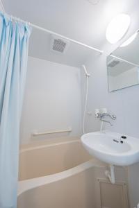 a bathroom with a sink and a shower at Extreme in Sapporo