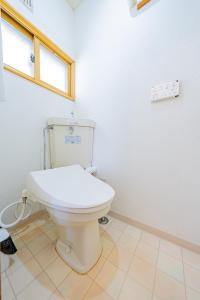 a bathroom with a white toilet in a room at Extreme in Sapporo