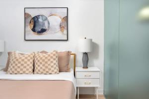 a bedroom with a bed and a picture on the wall at Urban Oasis Condo with Cafe & Bar at Your Doorstep in Toronto +13 photos
