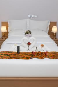 Voodi või voodid majutusasutuse Résidence La Paix Yamoussoukro, L'Oasis toas