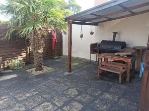 a patio with a grill and a bench and a piano at Chalet Faro in Mar del Plata