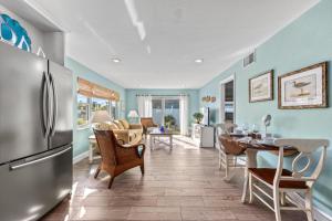 a kitchen and dining room with a refrigerator at Sand Dollar Suite - 632A in Siesta Key