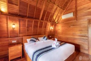 Ένα ή περισσότερα κρεβάτια σε δωμάτιο στο The Gili Menjangan