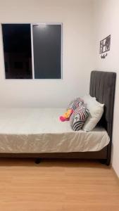 a bed sitting in a room with a window at Residência da day in Aracaju +13 photos