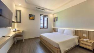 Giường trong phòng chung tại La Maison De Dino Hotels & Apartments Phú Quốc
