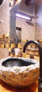 a bathroom with a large stone sink with a mirror at Ocres de mi Tierra in Tilcara