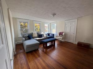 a living room with a couch and a table at Seaside Stay in Historic Warren in Warren