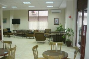a waiting room with tables and chairs and a tv at Bormali Hotel in Corlu