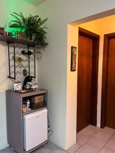 a room with a small refrigerator and a door at Apzinho do Centro in Nova Petrópolis +26 photos