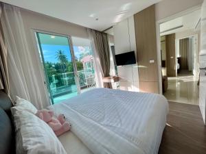 a bedroom with a bed and a large window at Bright 2BR Condo near Central Phuket FREE Pool Gym Parking in Ban Ket Ho