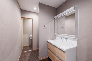 a bathroom with a white sink and a mirror at The Rabbit 兎a newly built vacation home in Inzai +63 photos