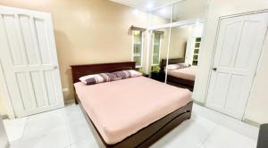a bedroom with two beds and a mirror at La Roma - Hot Spring Private Resort in Pansol