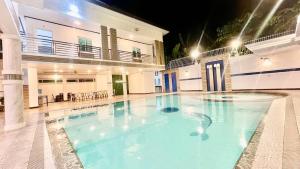 a large swimming pool in the middle of a building at La Roma - Hot Spring Private Resort in Pansol +18 photos