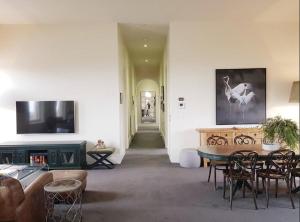 a living room with a table and a couch at PENTHOUSE at OZONE in Queenscliff