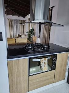 a kitchen with a stove and a counter top at Casa luz in Medellín