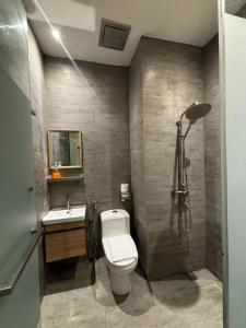 a bathroom with a toilet and a sink and a shower at iBilik Hotel - KLIA 1 KLIA 2, Sepang in Sepang +40 photos