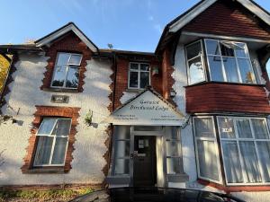 a building with a sign on the front of it at The Birchwood Lodge in Horley