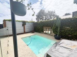 a small swimming pool in a backyard with a cactus at Hayes Haven Bunbury in Bunbury