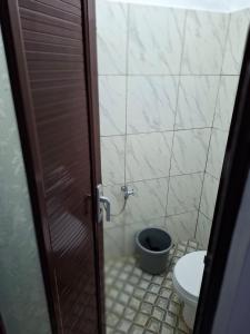 a bathroom with a toilet and a shower with a door at YouYouKe Papillon in Cilauteureun