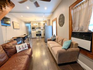 a living room with a couch and a dining room at Feline Twins in New Orleans