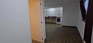 an empty room with a kitchen and a hallway at Dima's in Porto Seguro +25 photos
