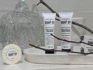a group of four products sitting on a counter next to a bottle at 23onWindsor in Hahndorf