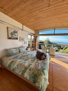 a bedroom with a bed with a bag on it at Hobart Hideaway Pods in Kingston