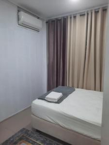 Postel nebo postele na pokoji v ubytování Ezy Nano Homestay