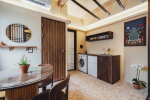 a kitchen and living room with a table and a sink at Korea's beauty in haeundae with Hinoki wooden bath in Busan +10 photos