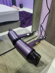 a purple hair dryer sitting on a table at Homestay MamaYa Tok Bok in Machang