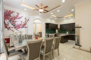 a kitchen and dining room with a table and chairs at Villa INDOCHINA 7 bed room in Ho Chi Minh City