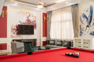 a living room with a red pool table at Villa INDOCHINA 7 bed room in Ho Chi Minh City