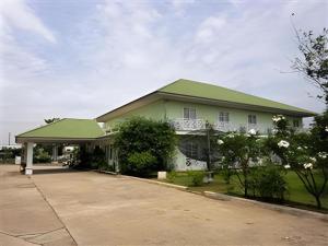 a large white house with a green roof at Kasem Garden Hotel Surin in Surin