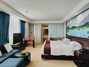 a hotel room with a bed and a large screen at Centenio International Hotel in Foshan +230 photos