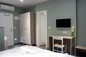 a bedroom with a bed and a tv on the wall at Iris Studios in Umag