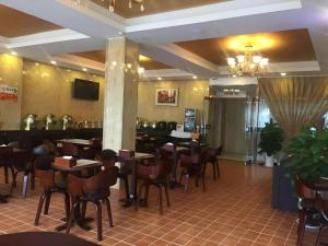 a restaurant with tables and chairs and a bar at GreenTree Inn Shandong Yuncheng Ximen Street Songjiang Kung Fu School Business Hotel in Yuncheng