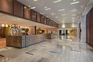 a lobby of a hotel with a reception desk at Regal Airport Hotel Xi'an in Xianyang