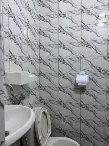 a bathroom with a white toilet and a sink at Mini studio in Dakar