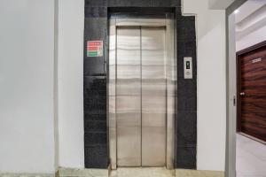 a elevator in a building next to a door at Hotel Aerotech Near Delhi Airport in New Delhi