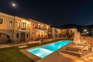 a swimming pool in the yard of a house at night at Anthelia in Skala Potamias