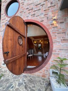 a circular wooden door in a brick wall at The Canopy house Private cozy stay Pai Mountains in Pai