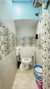 a bathroom with a toilet in a room at GM Residency in Varanasi
