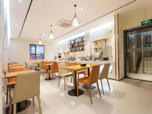 a restaurant with tables and chairs and a cafeteria at City Comfort Inn Liuzhou Sanjiang Gulou Bird's Nest in Sanjiang