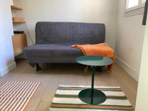 a living room with a couch and a table at Cosy Studio for 2 in Saint Germain des Pres in Paris +7 photos