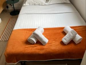 a bed with three rolled towels on top of it at Cosy Studio for 2 in Saint Germain des Pres in Paris