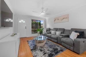 a living room with a couch and a table at Hilltop Residences Chermside in Brisbane