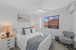 a white bedroom with a bed and a window at Hilltop Residences Chermside in Brisbane +12 photos