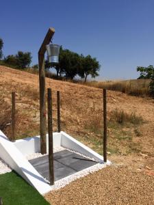 a water well with a bucket on a wooden pole at Monte do Espadanal in Cercal