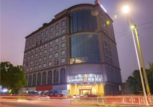 a building with a lot of windows and a street at Borrman Hotel Dongguan Zhongtang in Dongguan