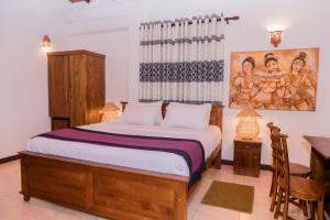 Ένα ή περισσότερα κρεβάτια σε δωμάτιο στο Daions Villa Mirissa